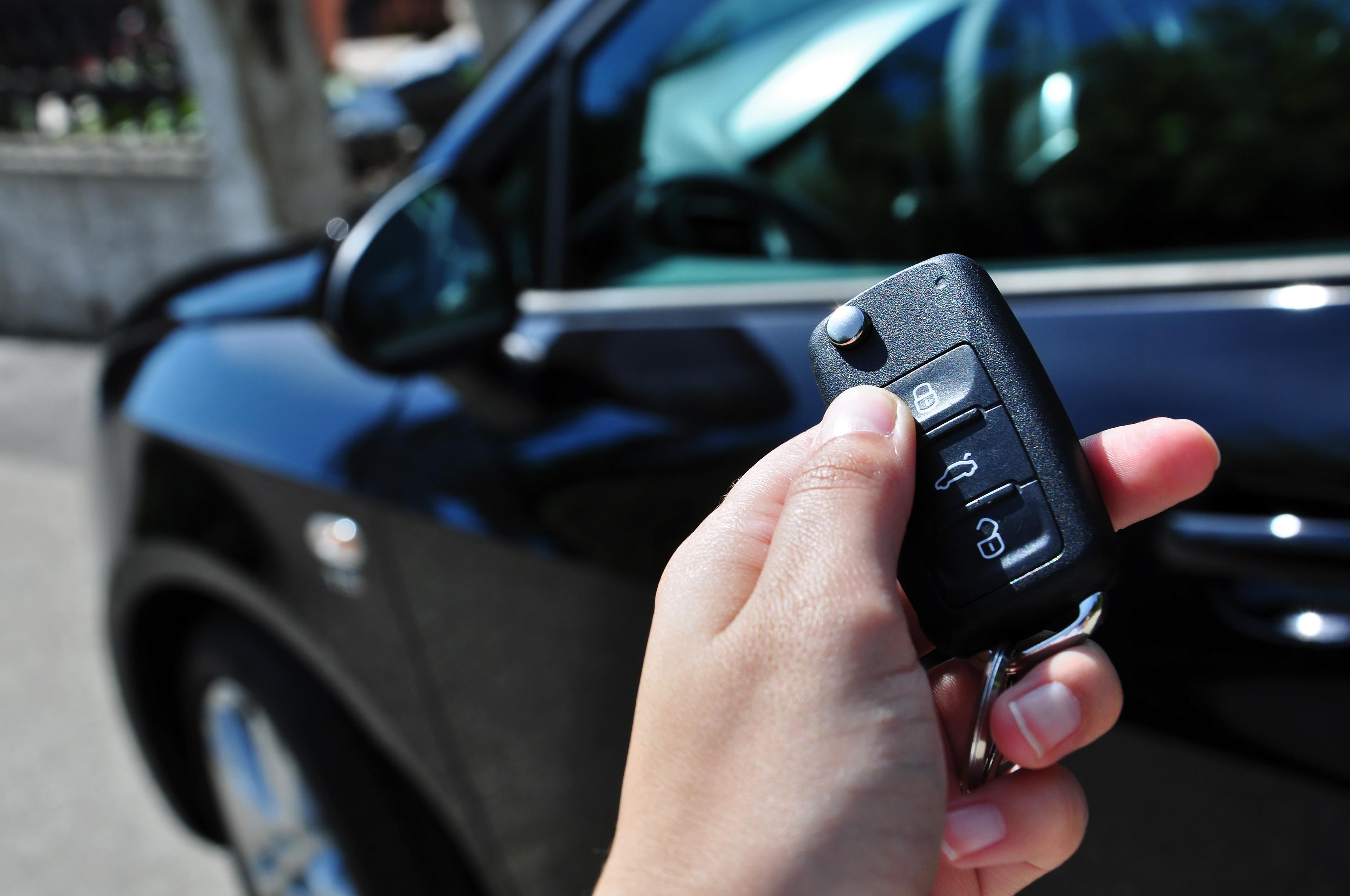Car key held up to a car