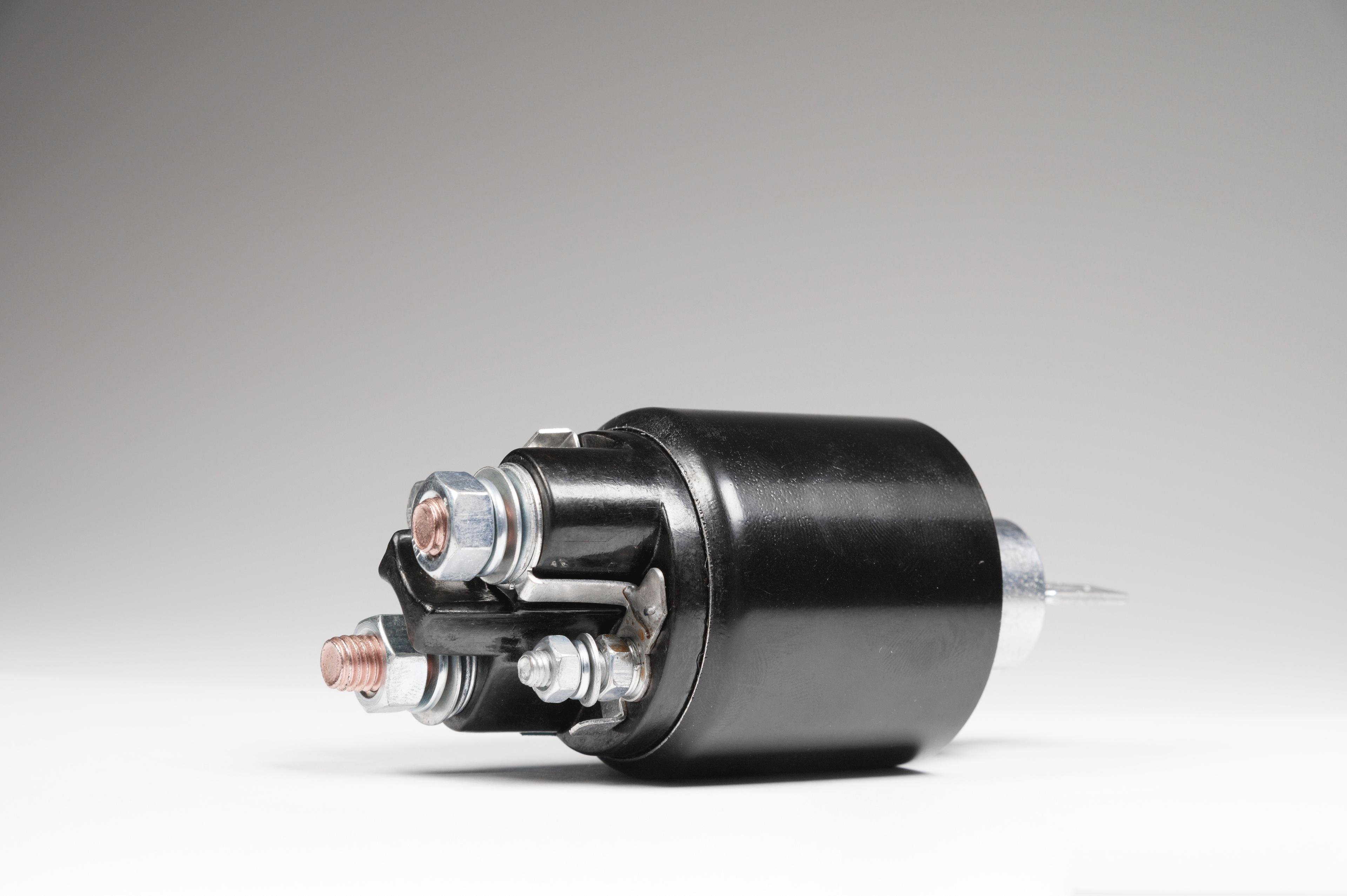 Starter motor on a grey background