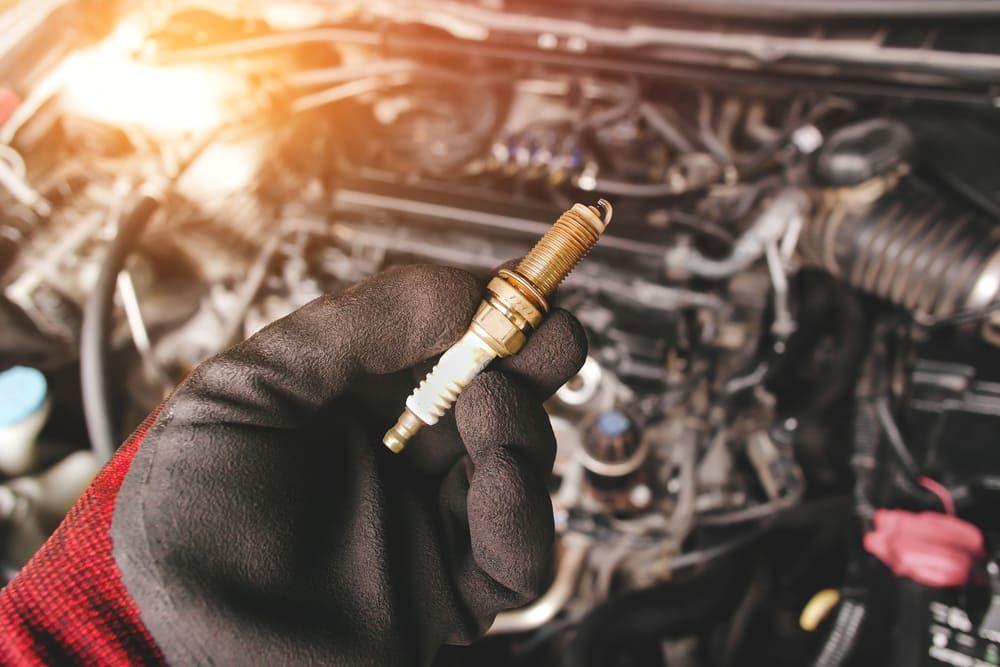 Mechanic changing spark plugs
