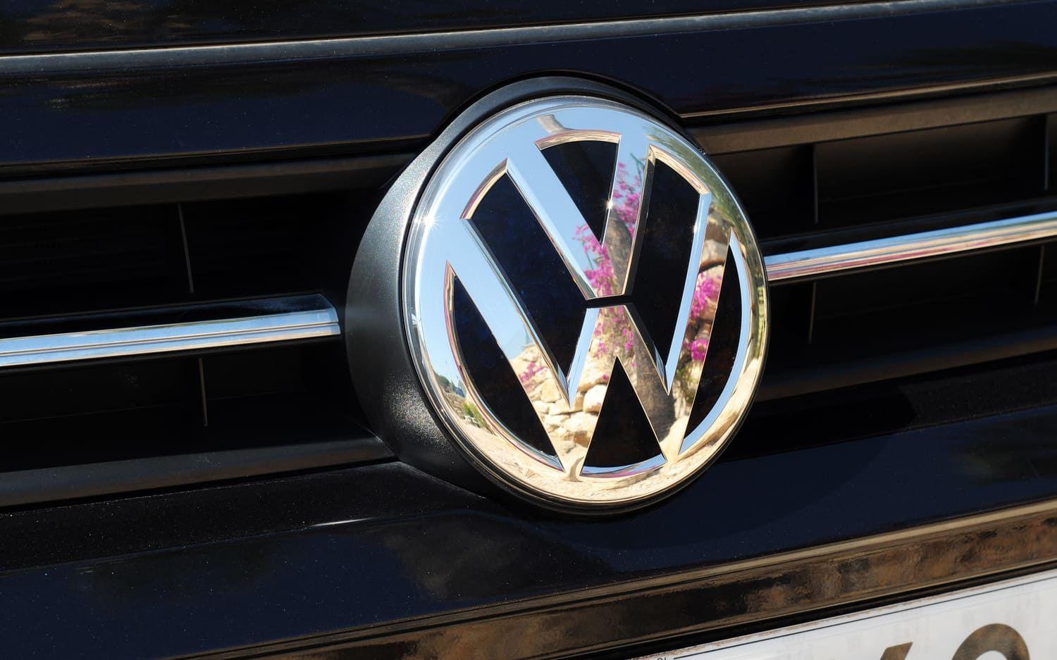 Silver VW badge on a black car