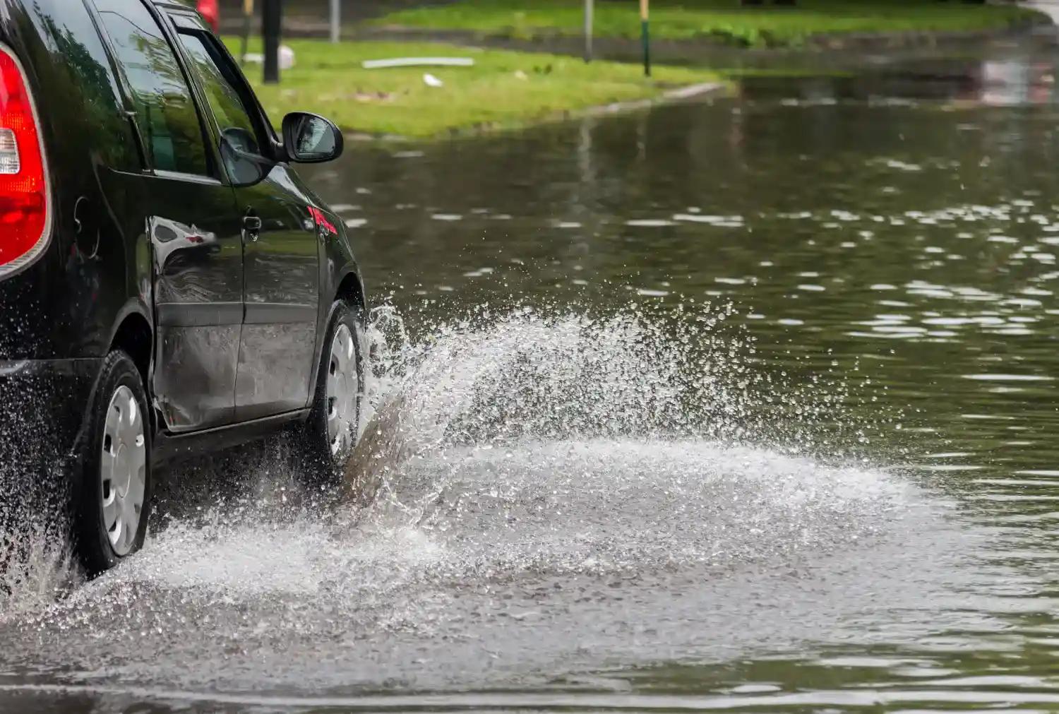 Car driving through puddle
