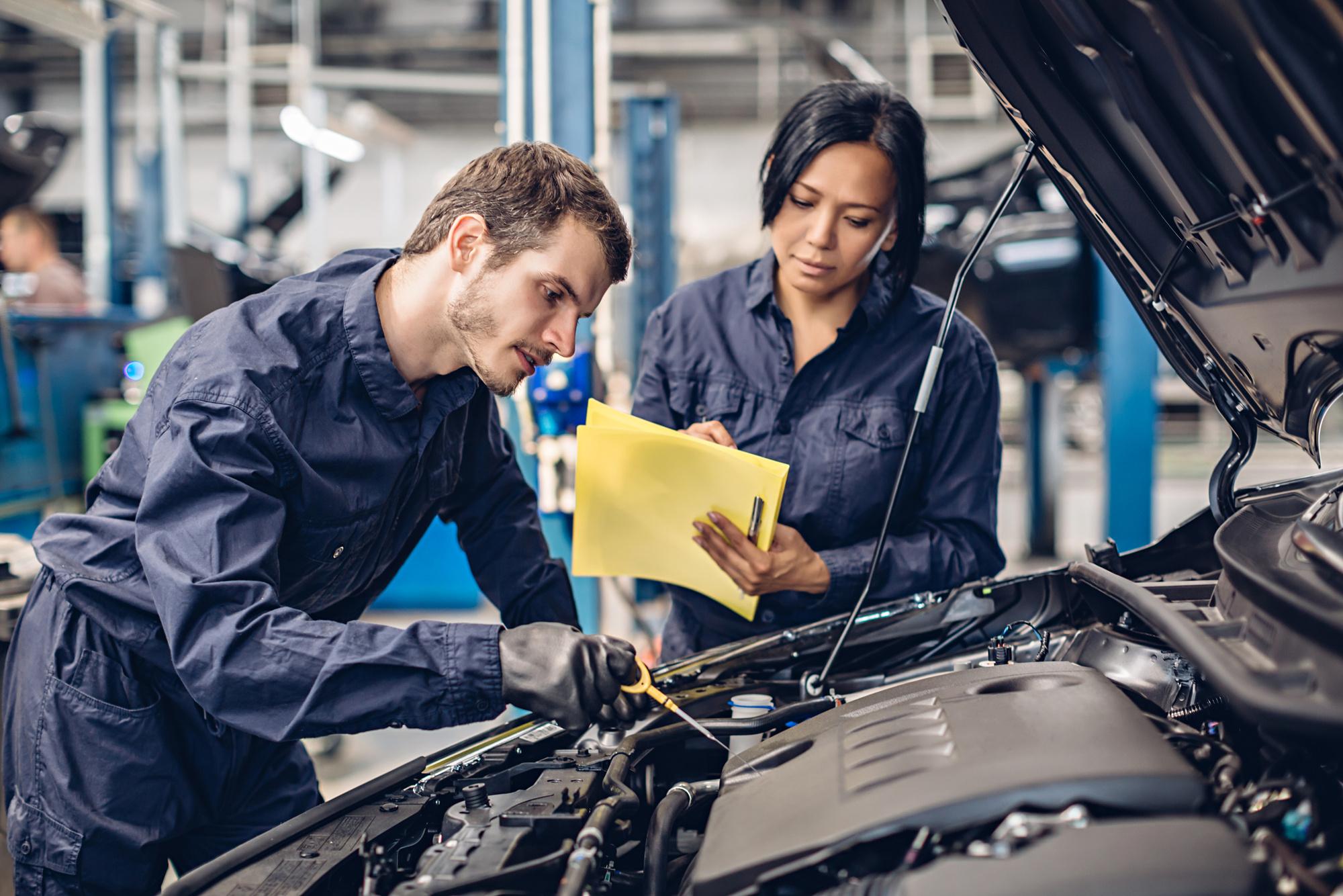 Mechanics work on a car