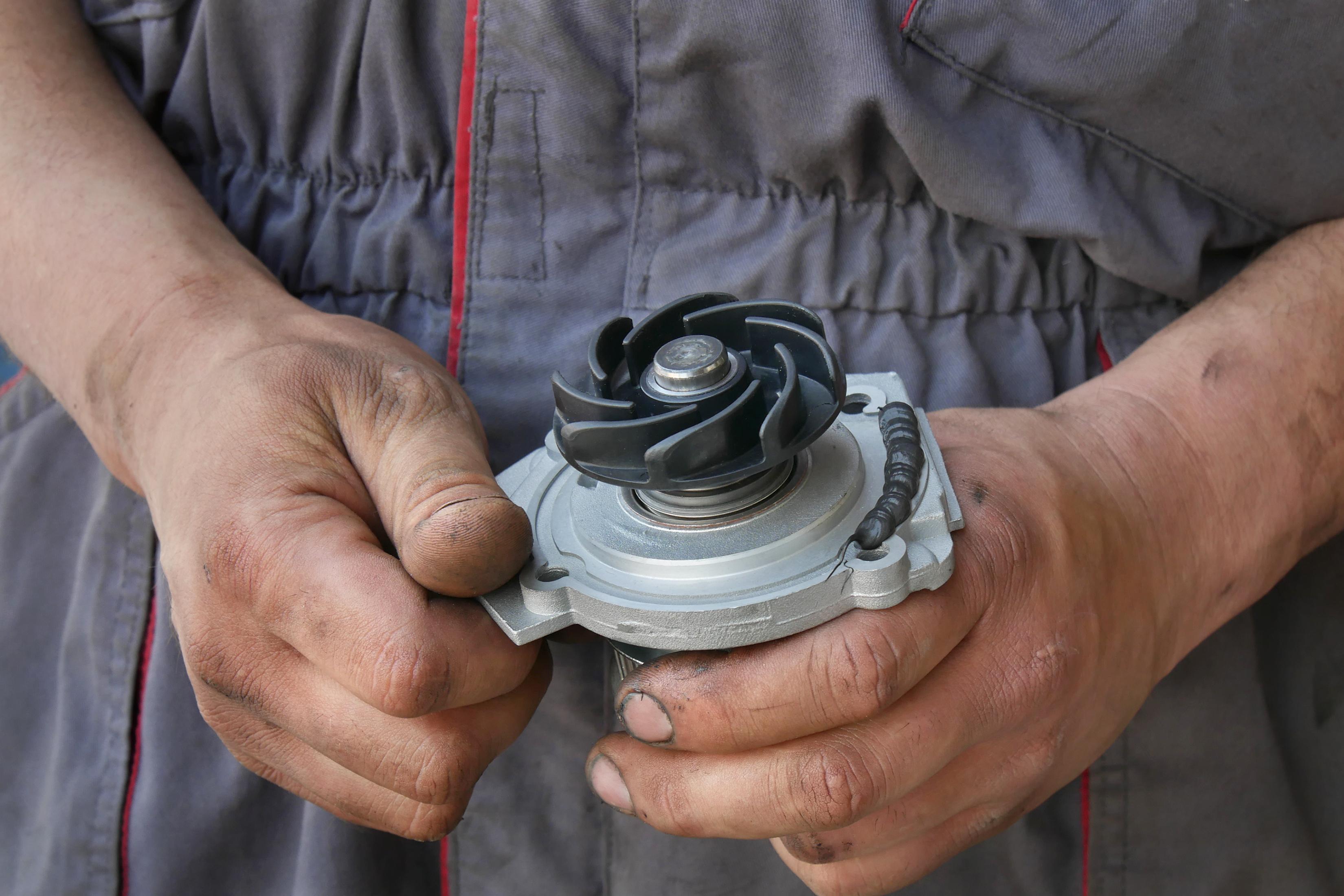 Mechanic holding a new waterpump