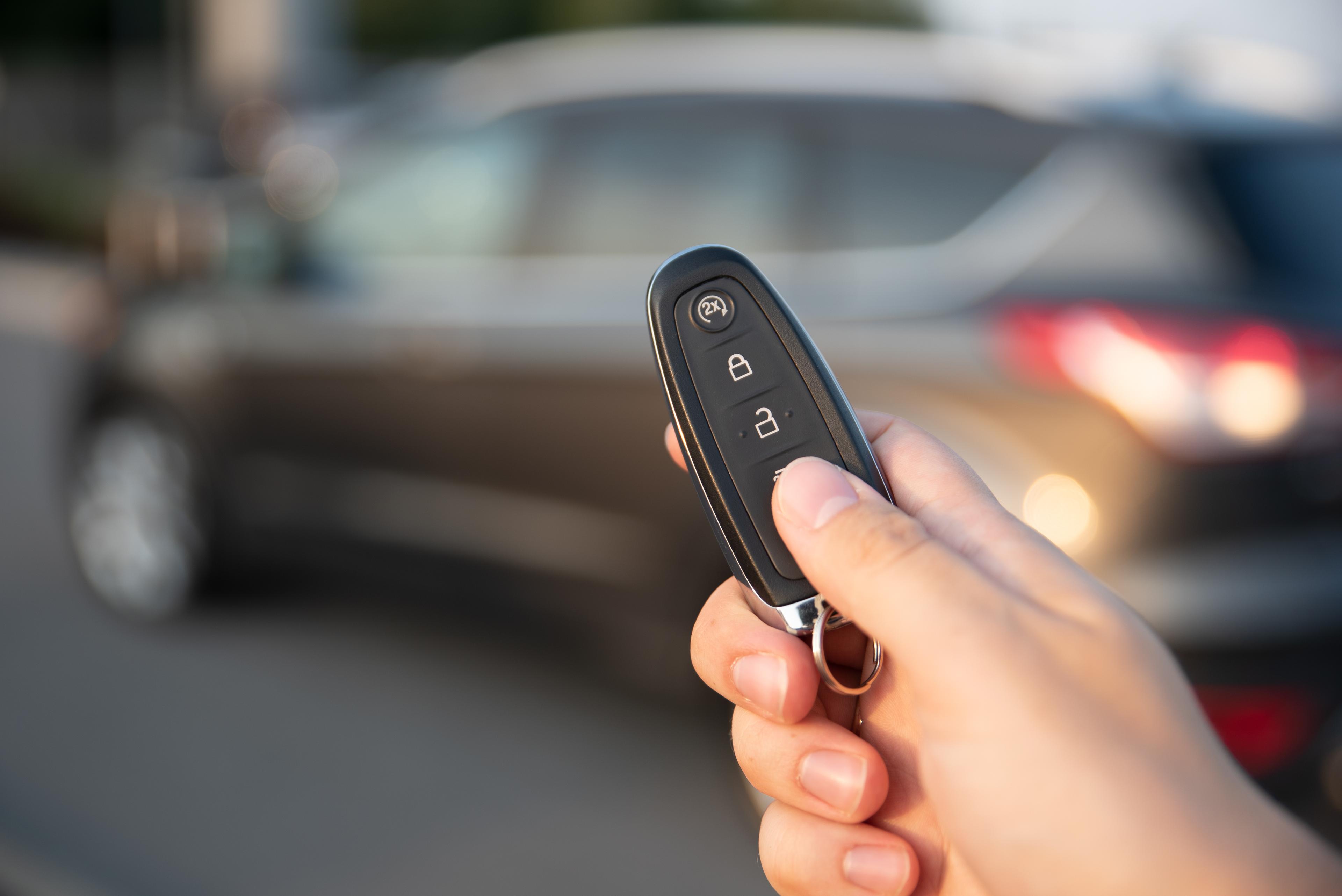 Driver uses a key to unlock a car door