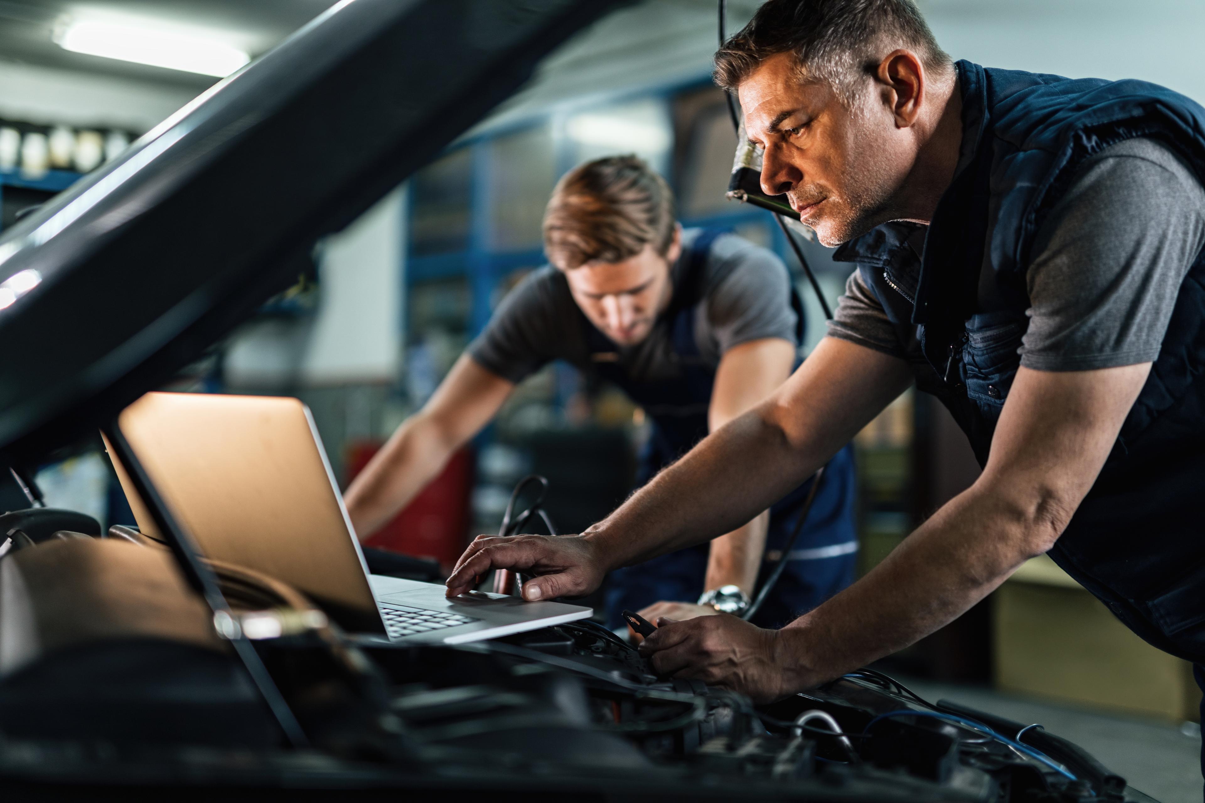 Mechanics running car diagnostics