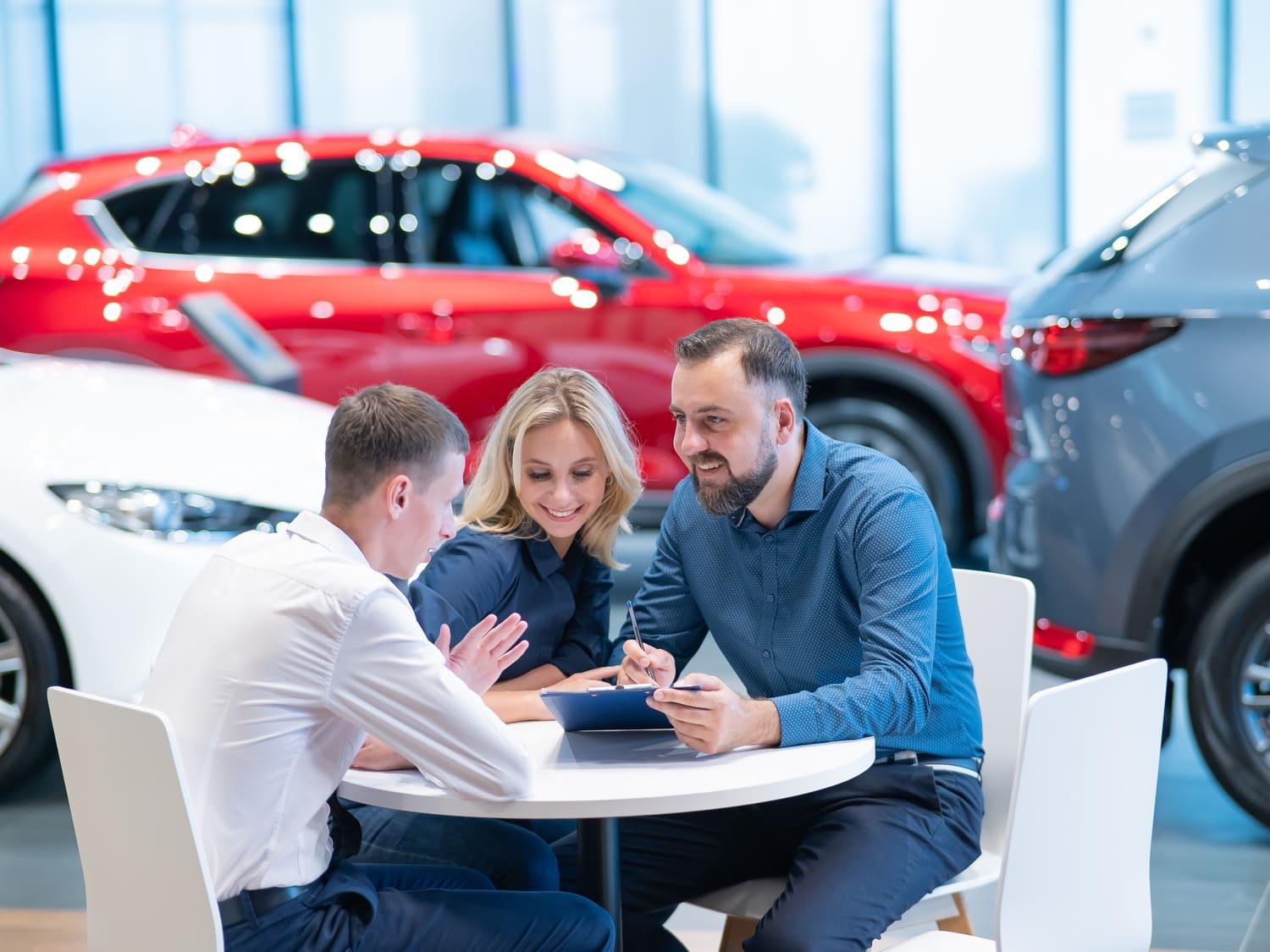 A couple discussing repairs at a dealership