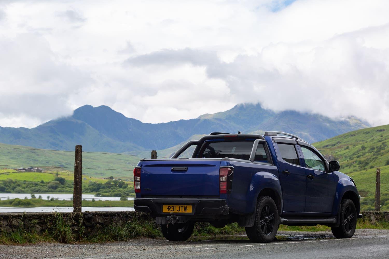 Blue pickup truck with mountain background