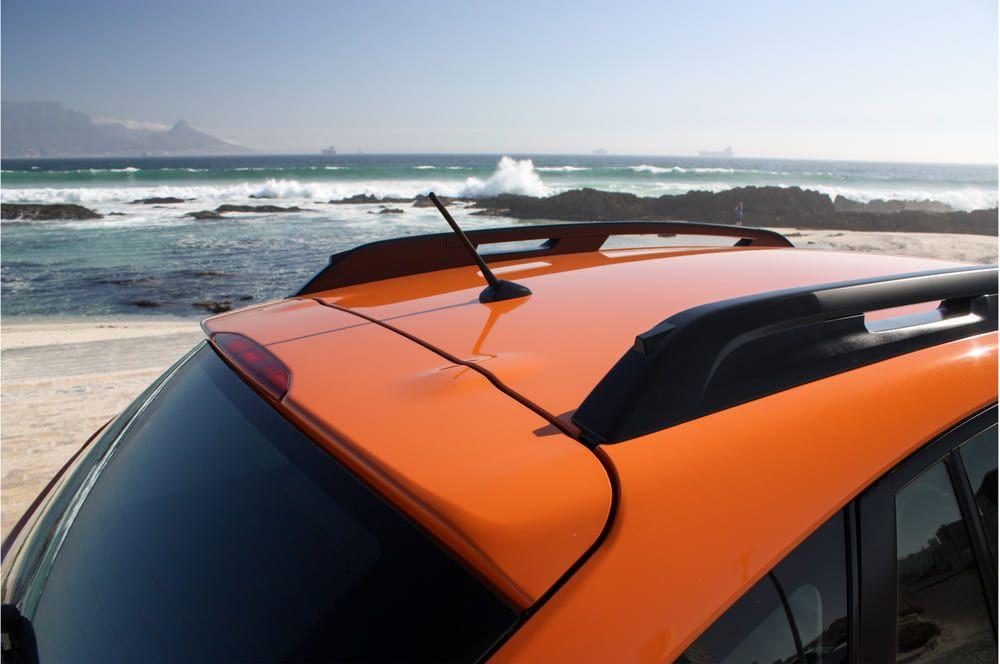 Bumper orange car parked by the sea