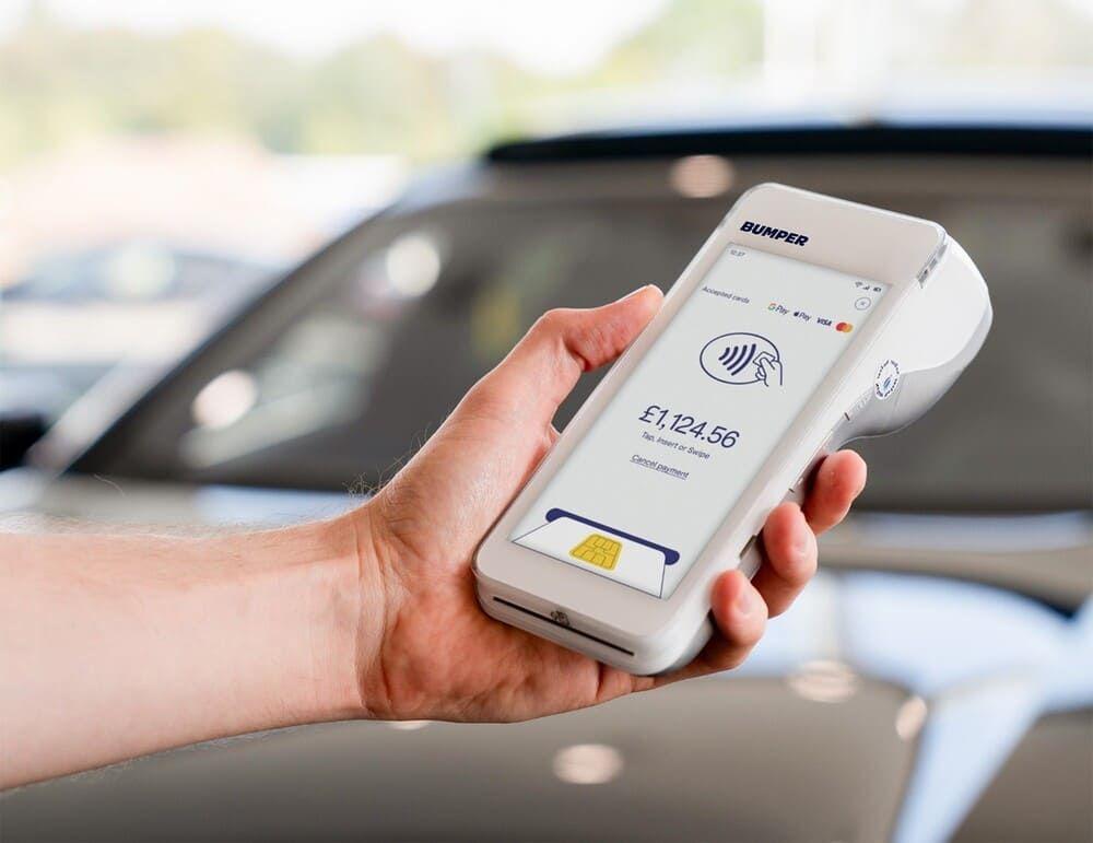 Service advisor holds Bumper PayPad